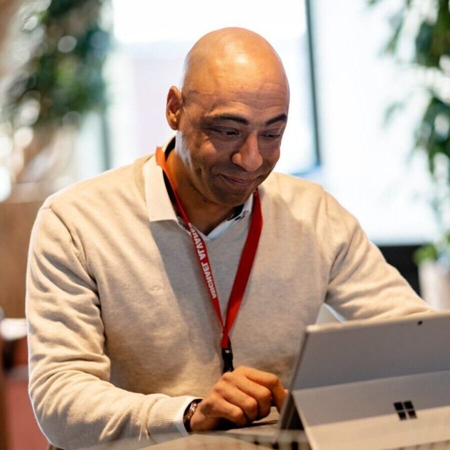colleague Michael Alvares behind laptop in Woerden office